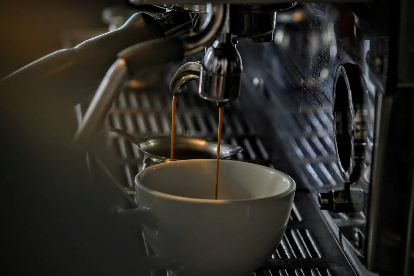 Espresso dripping from a steel portafilter at Cape Roast Co.