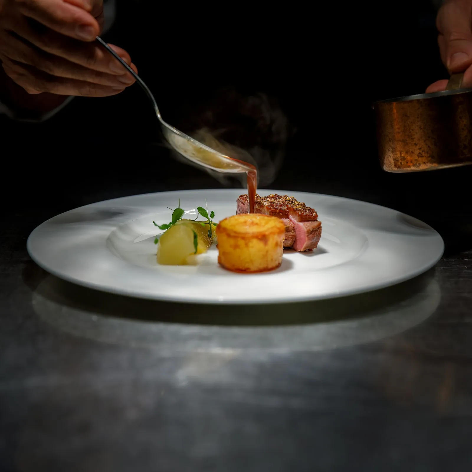 Chef plating a signature dish at Copper Pot Bistro