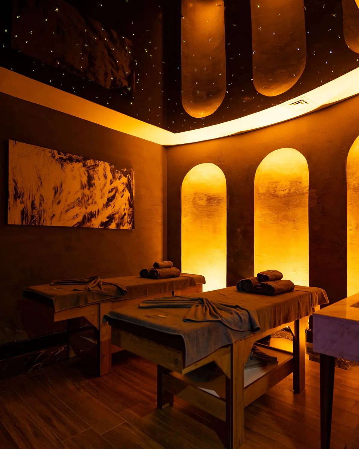 A serene candlelit treatment room at Halcyon Spa with warm, soft lighting