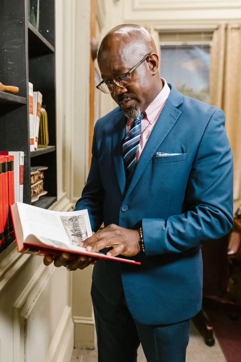Mokoena & Associates — attorney reviewing legal documents in a formal law office